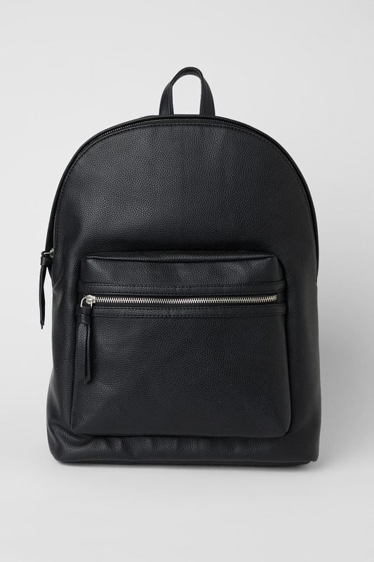 Black Grain Faux Leather Commuter Backpack Textured grain faux leather finish for a sophisticated appearance
Front zip pocket for easy access to essentials
Spacious main compartment ideal for daily commuting needs
Padded adjustable shoulder straps for comfortable carrying
Classic silhouette with clean lines for versatile styling
This commuter backpack combines practicality with understated style, perfect for the modern man on the move. The sleek design transitions effortlessly from morning commutes to weekend adventures, with ample space for your laptop, documents and daily essentials. Pair with tailored trousers and a crisp shirt for office days, or team with dark denim jeans and a casual jacket for pub meet-ups with mates. The durable construction makes it an ideal companion for sporting events or weekend trips away. The minimalist aesthetic ensures this backpack will complement your existing wardrobe without overwhelming your look. A practical yet stylish solution for the man who values both function and classic design in his everyday accessories.