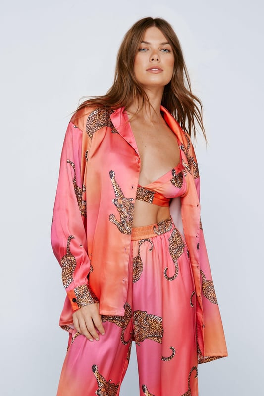 Wild thing. Our satin leopard pajamas are super luxurious, and will have you feeling refreshed come weekend lie-ins. Satin Leopard 3pc Shirt Bralette & Pants PJ Set PJ Shirt, Bralette, & Pants Set Satin Pajamas 3pc Set Long Sleeved Pajama Shirt Button Fastening Oversized Pajama Shirt Satin Bralette Satin Pajama Pants Comfortable High Waist Wide Leg Design Model wears a size M (US size 6/UK size 10).