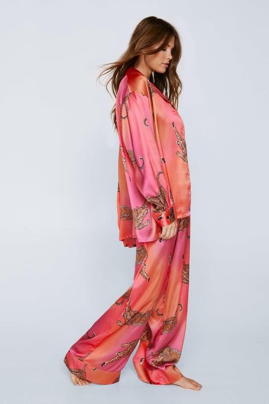 Wild thing. Our satin leopard pajamas are super luxurious, and will have you feeling refreshed come weekend lie-ins. Satin Leopard 3pc Shirt Bralette & Pants PJ Set PJ Shirt, Bralette, & Pants Set Satin Pajamas 3pc Set Long Sleeved Pajama Shirt Button Fastening Oversized Pajama Shirt Satin Bralette Satin Pajama Pants Comfortable High Waist Wide Leg Design Model wears a size M (US size 6/UK size 10).