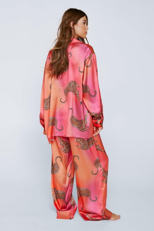 Wild thing. Our satin leopard pajamas are super luxurious, and will have you feeling refreshed come weekend lie-ins. Satin Leopard 3pc Shirt Bralette & Pants PJ Set PJ Shirt, Bralette, & Pants Set Satin Pajamas 3pc Set Long Sleeved Pajama Shirt Button Fastening Oversized Pajama Shirt Satin Bralette Satin Pajama Pants Comfortable High Waist Wide Leg Design Model wears a size M (US size 6/UK size 10).
