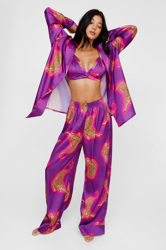 Wild thing. Our satin leopard pajamas are super luxurious, and will have you feeling refreshed come weekend lie-ins. Satin Leopard 3pc Shirt Bralette & Pants PJ Set PJ Shirt, Bralette, & Pants Set Satin Pajamas 3pc Set Long Sleeved Pajama Shirt Button Fastening Oversized Pajama Shirt Satin Bralette Satin Pajama Pants Comfortable High Waist Wide Leg Design Model wears a size M (US size 6/UK size 10).