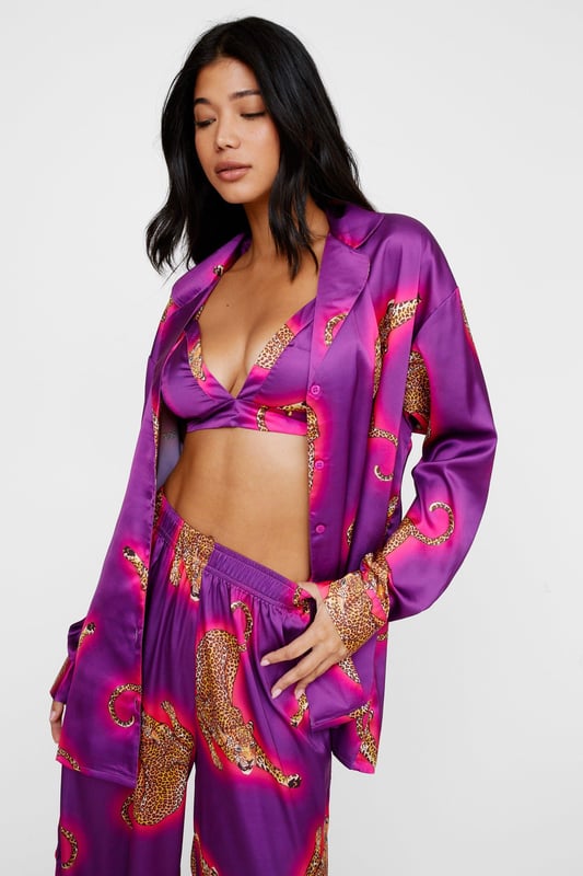 Wild thing. Our satin leopard pajamas are super luxurious, and will have you feeling refreshed come weekend lie-ins. Satin Leopard 3pc Shirt Bralette & Pants PJ Set PJ Shirt, Bralette, & Pants Set Satin Pajamas 3pc Set Long Sleeved Pajama Shirt Button Fastening Oversized Pajama Shirt Satin Bralette Satin Pajama Pants Comfortable High Waist Wide Leg Design Model wears a size M (US size 6/UK size 10).