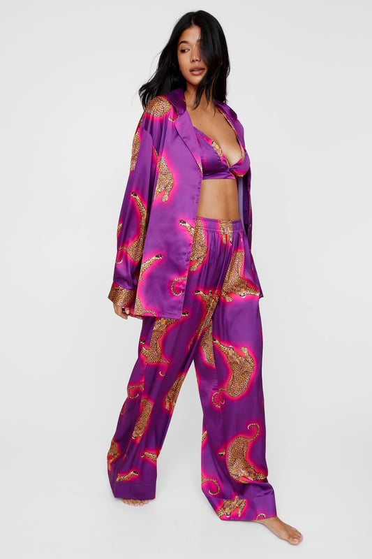 Wild thing. Our satin leopard pajamas are super luxurious, and will have you feeling refreshed come weekend lie-ins. Satin Leopard 3pc Shirt Bralette & Pants PJ Set PJ Shirt, Bralette, & Pants Set Satin Pajamas 3pc Set Long Sleeved Pajama Shirt Button Fastening Oversized Pajama Shirt Satin Bralette Satin Pajama Pants Comfortable High Waist Wide Leg Design Model wears a size M (US size 6/UK size 10).