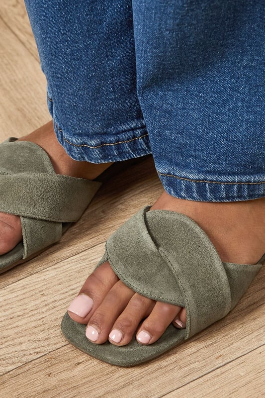 Luxurious suede leather construction
Elegant twist detail on the upper
Comfortable flat heel (0-2cm)
Versatile slip-on mule design
Open-toe silhouette for a breezy feel

Step into effortless chic with the Fleeta Suede Twist Flat Mules from Oasis. These sophisticated sandals blend comfort and style, making them a versatile addition to your wardrobe. The twisted suede upper adds a touch of intrigue, while the flat heel ensures all-day wearability. Perfect for casual outings, pair these mules with cropped jeans and a crisp white shirt for a polished daytime look. Alternatively, style them with a flowing maxi dress for a relaxed garden party ensemble. The neutral hue allows for endless styling possibilities, complementing both bold prints and understated solids. Whether you're running errands or meeting friends for brunch, these mules offer a refined finish to any outfit, embodying the feminine and pretty aesthetic that Oasis is known for.
** Please Note: Natural leather is a unique material that may exhibit slight variations in colour and texture. Due to the inherent characteristics of natural leather and the absence of synthetic coatings, some degree of colour transfer or fading may occur.