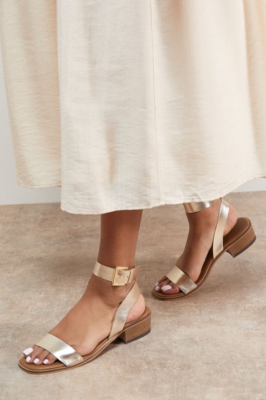 Genuine leather sandals with a comfortable mid-heel height of 5-6.5cm
        Minimalist design featuring a simple ankle strap with gold-tone buckle fastening
        Clean, open-toe silhouette perfect for showcasing pedicures
        Stacked block heel provides stability and all-day comfort
        Versatile design that pairs effortlessly with both casual and smart-casual outfits
    
    The Gracie Leather Sandals combine timeless style with everyday wearability. These versatile mid-heeled sandals feature a classic silhouette with a contemporary edge, making them a wardrobe essential for the warmer months. The ankle strap offers secure support whilst the modest block heel ensures comfort for extended wear. Style them with wide-leg denim and a broderie anglaise blouse for weekend brunches, or pair with a flowing midi dress for garden parties. These sandals transition seamlessly from day to evening, working beautifully with cropped trousers and a crisp shirt for casual office days. Their understated elegance makes them the perfect companion for summer holidays, city breaks, and casual gatherings where style and comfort are equally important.