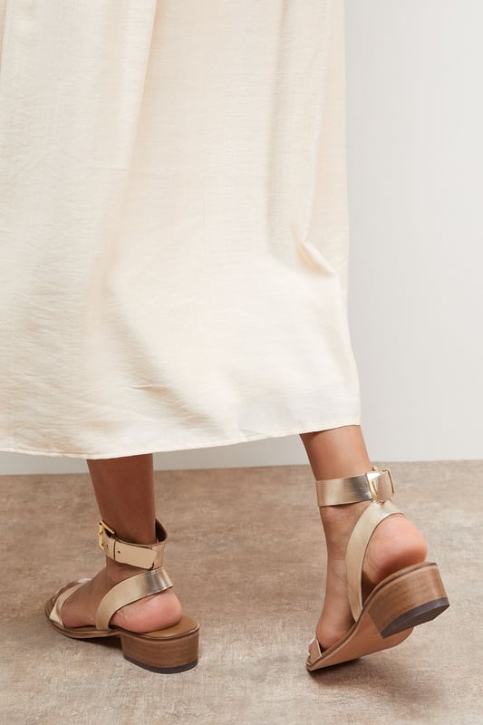 Genuine leather sandals with a comfortable mid-heel height of 5-6.5cm
        Minimalist design featuring a simple ankle strap with gold-tone buckle fastening
        Clean, open-toe silhouette perfect for showcasing pedicures
        Stacked block heel provides stability and all-day comfort
        Versatile design that pairs effortlessly with both casual and smart-casual outfits
    
    The Gracie Leather Sandals combine timeless style with everyday wearability. These versatile mid-heeled sandals feature a classic silhouette with a contemporary edge, making them a wardrobe essential for the warmer months. The ankle strap offers secure support whilst the modest block heel ensures comfort for extended wear. Style them with wide-leg denim and a broderie anglaise blouse for weekend brunches, or pair with a flowing midi dress for garden parties. These sandals transition seamlessly from day to evening, working beautifully with cropped trousers and a crisp shirt for casual office days. Their understated elegance makes them the perfect companion for summer holidays, city breaks, and casual gatherings where style and comfort are equally important.