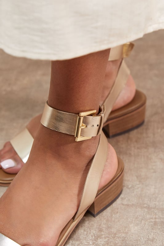 Genuine leather sandals with a comfortable mid-heel height of 5-6.5cm
        Minimalist design featuring a simple ankle strap with gold-tone buckle fastening
        Clean, open-toe silhouette perfect for showcasing pedicures
        Stacked block heel provides stability and all-day comfort
        Versatile design that pairs effortlessly with both casual and smart-casual outfits
    
    The Gracie Leather Sandals combine timeless style with everyday wearability. These versatile mid-heeled sandals feature a classic silhouette with a contemporary edge, making them a wardrobe essential for the warmer months. The ankle strap offers secure support whilst the modest block heel ensures comfort for extended wear. Style them with wide-leg denim and a broderie anglaise blouse for weekend brunches, or pair with a flowing midi dress for garden parties. These sandals transition seamlessly from day to evening, working beautifully with cropped trousers and a crisp shirt for casual office days. Their understated elegance makes them the perfect companion for summer holidays, city breaks, and casual gatherings where style and comfort are equally important.