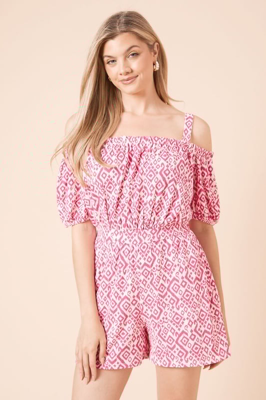 Striking bardot neckline with adjustable shoulder straps for versatile styling options
        Feminine puff sleeves add a touch of romantic flair to this jersey playsuit
        Elasticated waistband creates a flattering silhouette while ensuring all-day comfort
        Relaxed fit shorts provide ease of movement for casual summer days
        Geometric print pattern adds visual interest to this effortlessly chic one-piece
    
    This charming bardot playsuit from Dorothy Perkins combines comfort with casual elegance. The off-shoulder design with puff sleeves creates a feminine silhouette, while the elasticated waist defines your shape beautifully. Perfect for summer brunches with friends or family gatherings, this playsuit requires minimal styling effort for maximum impact. Pair with white flat sandals and a woven handbag as shown for a relaxed daytime look, or dress up with espadrille wedges for garden parties. The jersey fabric ensures this piece remains comfortable throughout the day, making it ideal for those occasions when you want to look put-together without sacrificing comfort. Add simple stud earrings to complete this effortlessly stylish ensemble that transitions seamlessly from casual coffee dates to afternoon baby showers.