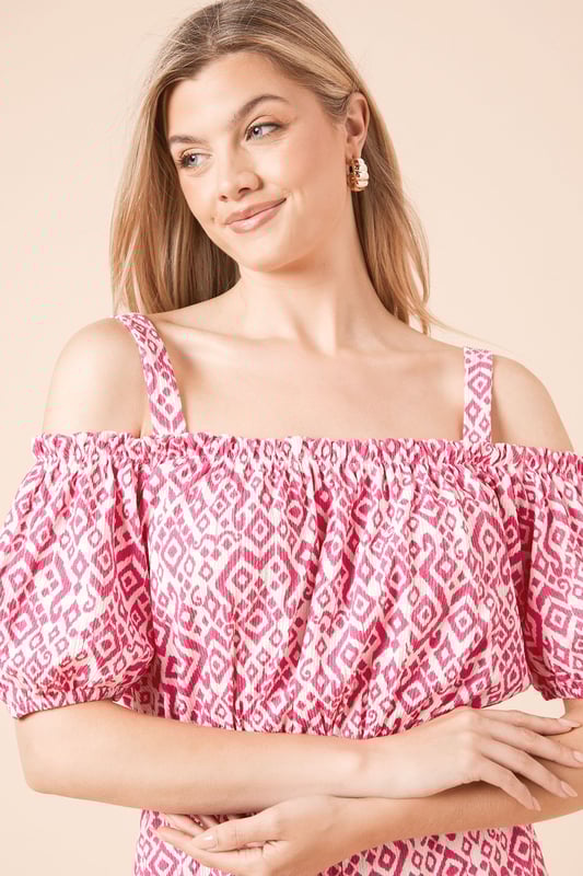 Striking bardot neckline with adjustable shoulder straps for versatile styling options
        Feminine puff sleeves add a touch of romantic flair to this jersey playsuit
        Elasticated waistband creates a flattering silhouette while ensuring all-day comfort
        Relaxed fit shorts provide ease of movement for casual summer days
        Geometric print pattern adds visual interest to this effortlessly chic one-piece
    
    This charming bardot playsuit from Dorothy Perkins combines comfort with casual elegance. The off-shoulder design with puff sleeves creates a feminine silhouette, while the elasticated waist defines your shape beautifully. Perfect for summer brunches with friends or family gatherings, this playsuit requires minimal styling effort for maximum impact. Pair with white flat sandals and a woven handbag as shown for a relaxed daytime look, or dress up with espadrille wedges for garden parties. The jersey fabric ensures this piece remains comfortable throughout the day, making it ideal for those occasions when you want to look put-together without sacrificing comfort. Add simple stud earrings to complete this effortlessly stylish ensemble that transitions seamlessly from casual coffee dates to afternoon baby showers.