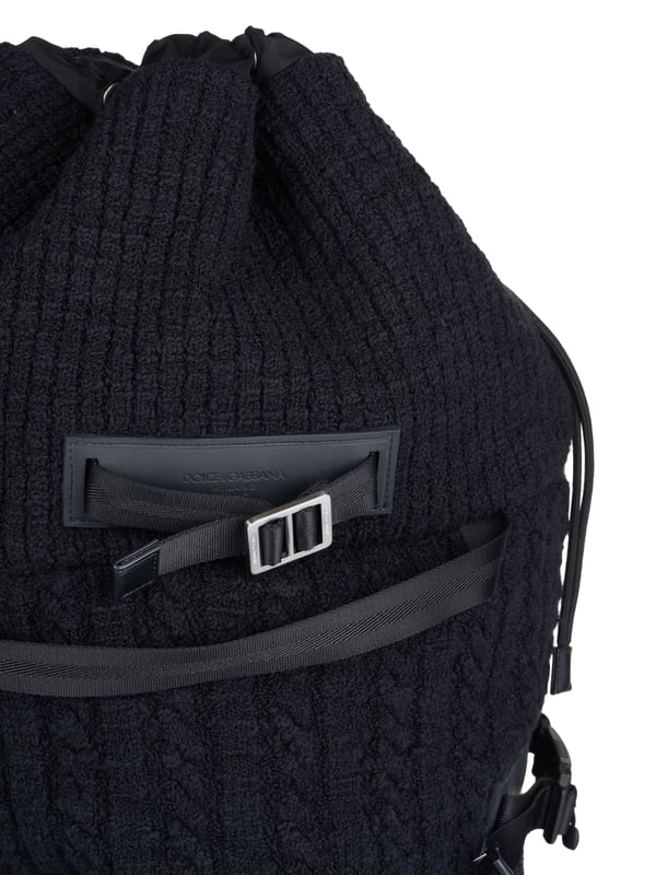 Dolce & Gabbana Duffel bag black 80% Virgin Wool, 10% Calf leather, 8% Polyamide, 2% Acrylic; Dolce & Gabbana duffel bag; Model: BM1904 AW911 8B979; High quality manufactured; Made in Italy; Soft virgin wool blend; One main compartment with drawstring; Two inside compartments, one of which has a zip; Four handles; Two adjustable shoulder straps; Adjustable side straps; Leather details; Silver-coloured metal details; Dimensions (cm): 64 x 40 x 21; Dolce & Gabbana logo details