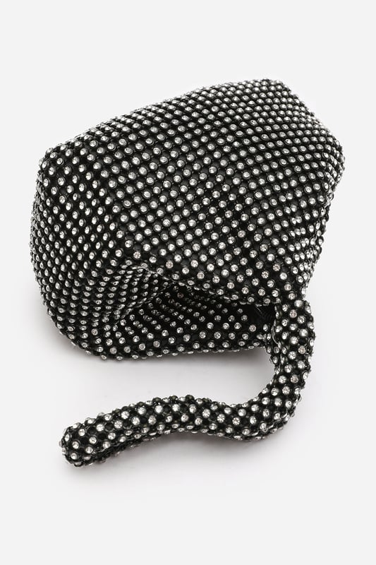 Add sparkle to your night with this Cascabel mini chainmail pouch bag, designed to dazzle at parties, weddings, or festive occasions. Its compact silhouette features shimmering crystal-style embellishments and a stylish knotted wristlet strap for easy carrying. Lightweight yet eye-catching, it's the perfect accessory for carrying your small essentials in glamorous style. A chic statement piece that blends retro charm with modern flair. Key Features: • Material: Rhinestone-embellished chainmail mesh • Dimensions: 16cm (L) x 14cm (H) x 10cm (W) • Fastening: Hidden zip closure at the top • Detail: Knotted wristlet strap for a secure and stylish hold