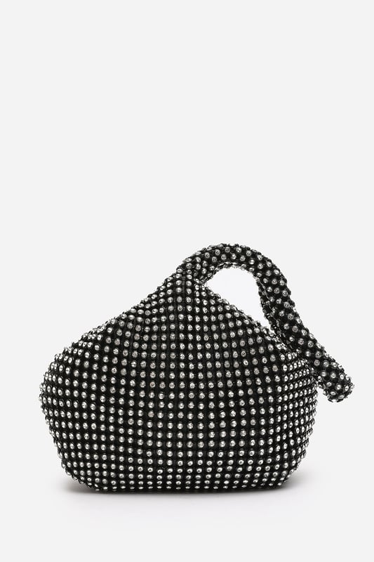 Add sparkle to your night with this Cascabel mini chainmail pouch bag, designed to dazzle at parties, weddings, or festive occasions. Its compact silhouette features shimmering crystal-style embellishments and a stylish knotted wristlet strap for easy carrying. Lightweight yet eye-catching, it's the perfect accessory for carrying your small essentials in glamorous style. A chic statement piece that blends retro charm with modern flair. Key Features: • Material: Rhinestone-embellished chainmail mesh • Dimensions: 16cm (L) x 14cm (H) x 10cm (W) • Fastening: Hidden zip closure at the top • Detail: Knotted wristlet strap for a secure and stylish hold