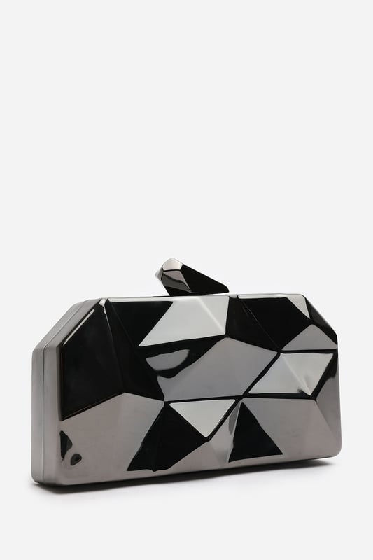 Turn heads with this striking Rica geometric clutch bag, designed to make a bold fashion statement at any evening event. The angular, high-gloss surface creates a modern 3D effect that reflects light from every angle. Its compact hard case keeps essentials secure while offering standout style. Perfect for weddings, parties, or night outs. Key Features: • Material: High-shine acrylic hard case with faceted geometric design • Dimensions: 18cm (L) x 9cm (H) x 6cm (W) • Fastening: Top snap clasp closure • Detail: Unique polygonal surface with a sculptural silhouette