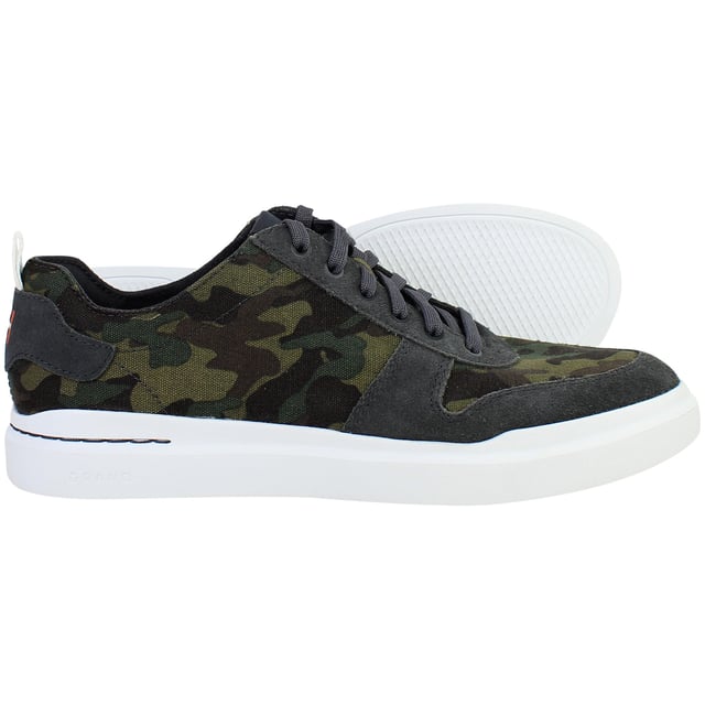 Bold yet refined, the Cole Haan GrandPrø Rally Men’s Trainers in Camo Green fuse athletic performance with elevated street style. With lightweight construction, cushioned comfort, and a distinctive camouflage print, these trainers are made for men who move confidently between work, play, and everything in between.
Key Features
Lightweight EVA Midsole

Engineered for soft, responsive cushioning and a featherlight feel ideal for all-day wear.

Classic Low-Top Sneaker Silhouette

Inspired by court heritage with a clean, modern twist that fits seamlessly into casual or smart-casual wardrobes.

Ortholite® Footbed

Provides moisture-wicking, breathable support and long-lasting underfoot comfort.

Durable Rubber Outsole with Traction Pods

Delivers stability, grip, and flexibility for versatile movement across everyday surfaces.

Secure Lace-Up Closure

Offers a snug, adjustable fit while maintaining a streamlined look.

Padded Collar and Tongue

Enhance ankle comfort and support, whether you’re on the move or on your feet all day.

Camo Green Colourway

Subtle yet statement-making—pairs easily with denim, joggers, or tapered trousers.


From city streets to casual weekends, the Cole Haan GrandPrø Rally Men’s Camo Green Trainers deliver modern comfort and confident style—crafted for everyday versatility with a bold edge.