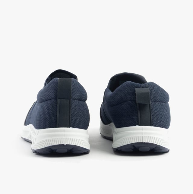 These wide-fit men's trainers feature a textile upper and lining with a rubber sole, offering comfort and breathability. Ideal for casual wear with a low-top design and slip-on closure