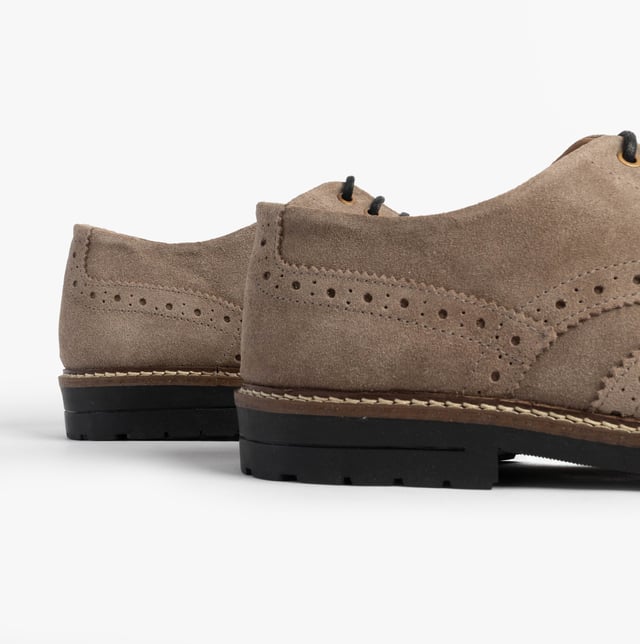 These beige brogue shoes feature a suede upper, textile lining, rubber sole, and lace-up closure. Designed for comfort, they are suitable for formal occasions and low-top style