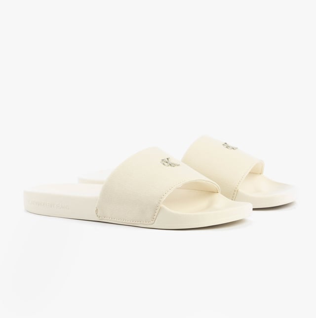 These women's sliders feature a cotton upper, polyester lining, and lightweight EVA sole. Designed for comfort and casual wear, they are slip-on with a flat heel for easy all-day use
