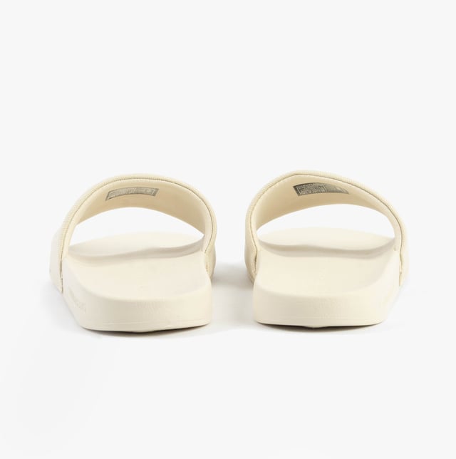 These women's sliders feature a cotton upper, polyester lining, and lightweight EVA sole. Designed for comfort and casual wear, they are slip-on with a flat heel for easy all-day use