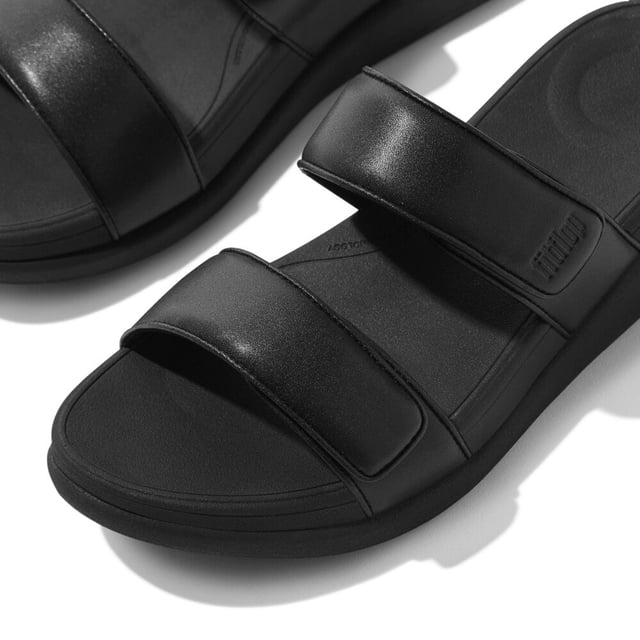 These slip-on women's slides feature a leather upper and lining, EVA sole, and wedge heel for comfort and breathability, ideal for casual wear