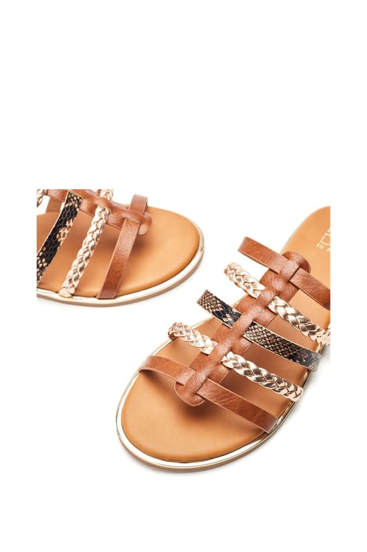 Introducing Junie, the essential flat for the summer season. This slip-on style features a front strap design with leather lining to ensure you feel as good as you look.