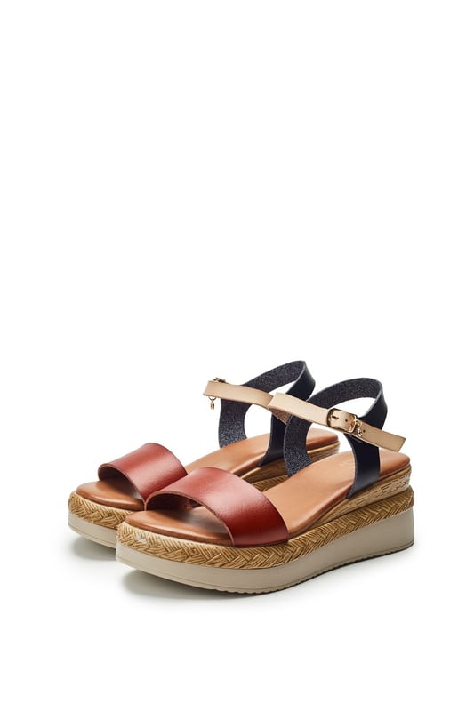 Keep your feet cool this season with Nyx, a low wedge heeled sandal that offers the perfect blend of classic sandals style and cool comfort. Complete with metallic buckle detailing and an easy to wear wedge, this style embodies both fashion and practicality.