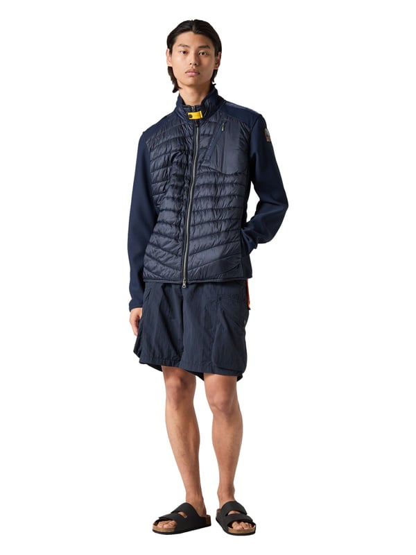Een sportieve look ontmoet slimme functie - dit jack combineert beide in stijl. De slim fit creëert een modern, nauwsluitend silhouet. De mix van materialen creëert een spannend contrast tussen structuur en comfort. De opstaande kraag met iconisch geel parachutehaaklint voegt een opvallend detail toe. Met de praktische ritszakken op de borst en rug zijn essentiële spullen altijd binnen handbereik. De zijzakken nodigen uit om je handen vrij te houden. Een tweewegritssluiting zorgt voor flexibiliteit, zowel op de fiets als tijdens een wandeling. Een labelpatch en subtiele logodetails ronden het authentieke ontwerp af. Het hoogwaardige materiaal voelt aangenaam licht aan - zelfs op koelere dagen. Dit jack is de ideale metgezel voor mannen met stijl en raffinement!