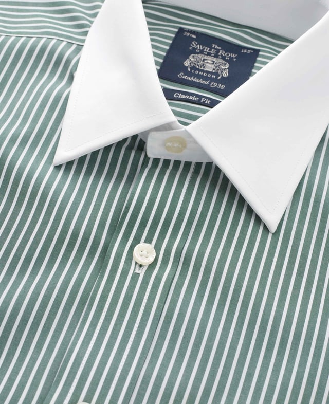A nod to classic Winchester heritage, this dark green formal shirt features bold reverse stripes paired with a crisp white collar and matching cuffs. Crafted from 100% cotton for lasting comfort, it's the ultimate statement piece for the office - where tradition meets unmistakable style. Contrast white curl resistant Windsor collar, with an integral and removable collar stay. 100% BCI cotton poplin; smooth to the touch, classic reverse stripe design. Generously proportioned classic fit. Curl resistant Windsor collar. Contrast white collar and cuffs. Split yoke, long tails, chest pocket. Machine washable at 40°C. We advise washing with a colour catcher for best results.
