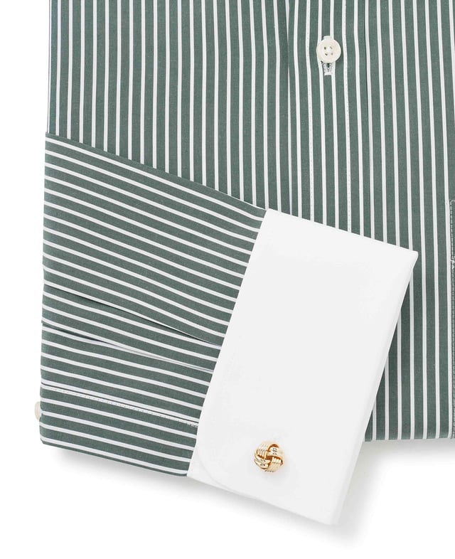 A nod to classic Winchester heritage, this dark green formal shirt features bold reverse stripes paired with a crisp white collar and matching cuffs. Crafted from 100% cotton for lasting comfort, it's the ultimate statement piece for the office - where tradition meets unmistakable style. Contrast white curl resistant Windsor collar, with an integral and removable collar stay. 100% BCI cotton poplin; smooth to the touch, classic reverse stripe design. Generously proportioned classic fit. Curl resistant Windsor collar. Contrast white collar and cuffs. Split yoke, long tails, chest pocket. Machine washable at 40°C. We advise washing with a colour catcher for best results.