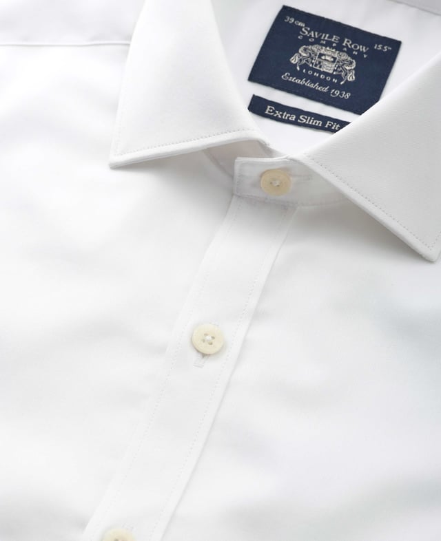 Cut to our most tailored fit, this extra slim white shirt will become the foundation of your favourite ensembles. It's made from soft cotton and finished with a curl-resistant collar and single cuffs. 100% BCI cotton twill; smooth and supple with a silk protein easy-care finish. Our slimmest fit, skimming the body. Curl resistant cutaway collar, with an integral and removable collar stay. Pucker-free french taped armhole seams. Single cuff. Split yoke, two back darts. Shirt is presented in fully recyclable packaging.