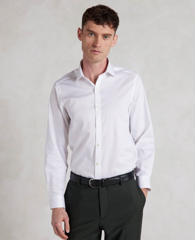 Cut to our most tailored fit, this extra slim white shirt will become the foundation of your favourite ensembles. It's made from soft cotton and finished with a curl-resistant collar and single cuffs. 100% BCI cotton twill; smooth and supple with a silk protein easy-care finish. Our slimmest fit, skimming the body. Curl resistant cutaway collar, with an integral and removable collar stay. Pucker-free french taped armhole seams. Single cuff. Split yoke, two back darts. Shirt is presented in fully recyclable packaging.