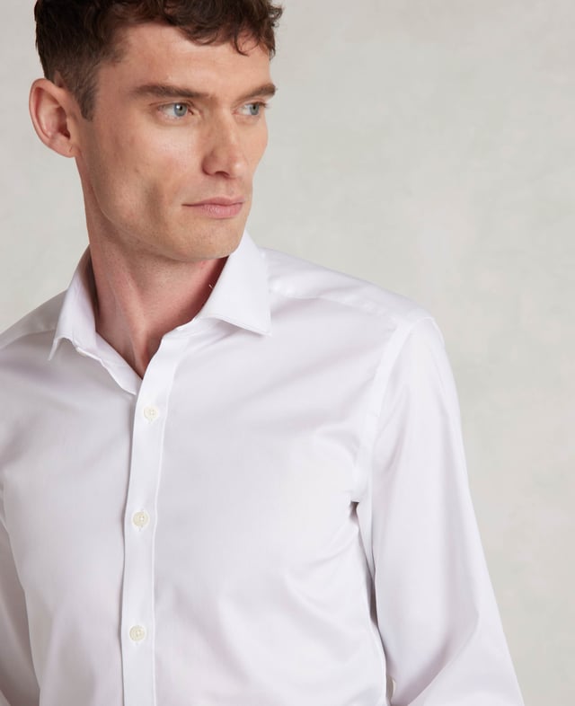 Cut to our most tailored fit, this extra slim white shirt will become the foundation of your favourite ensembles. It's made from soft cotton and finished with a curl-resistant collar and single cuffs. 100% BCI cotton twill; smooth and supple with a silk protein easy-care finish. Our slimmest fit, skimming the body. Curl resistant cutaway collar, with an integral and removable collar stay. Pucker-free french taped armhole seams. Single cuff. Split yoke, two back darts. Shirt is presented in fully recyclable packaging.