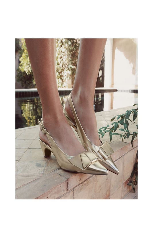 Navigate the season in Nutmeg, the slingback, kitten-heel sandal. This style features a chic pointed toe with a bow embellishment. The low heel provides wearable height, whilst the leather lining ensures all-day comfort.