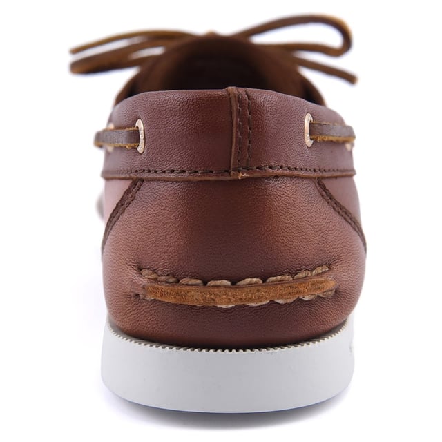 The womens Authentic Original 1-Eye Boat Shoe offers a timeless look anchored in the traditions of coastal style. This classic boat shoe features a luxurious leather upper, with refined copper eyelets, traditional moccasin stitching and rawhide laces