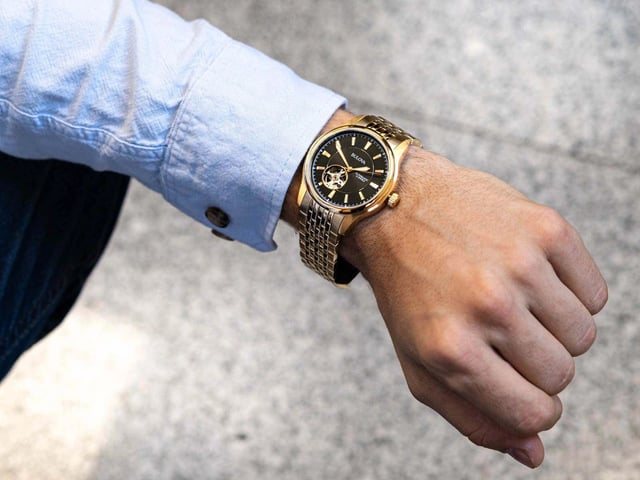 This Bulova Open Heart Analogue Watch for Men is the perfect timepiece to wear or to gift. It's Gold 40 mm Round case combined with the comfortable Gold Stainless steel watch band will ensure you enjoy this stunning timepiece without any compromise. Operated by a high quality Automatic movement and water resistant to 3 bars, your watch will keep ticking. This watch has an automatic watch movement ( recharged by any movement with your wrist; never needs a battery)  This Analogue watch is equipped with a Luminous Hands High quality Gold Stainless steel strap, measuring 21 cm in length and 19 mm in width, with a Fold over with push button clasp. Case diameter: 40 mm,case thickness: 11 mm, case colour: Gold and dial colour: Black