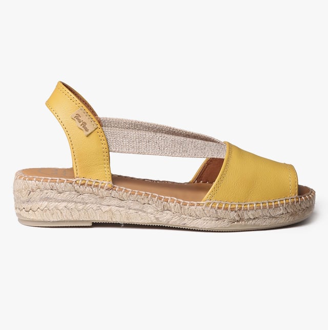 Leather espadrille sandals with a wedge heel, breathable lining, and slip-on design. Ideal for casual wear, featuring a low heel and rubber sole for comfort