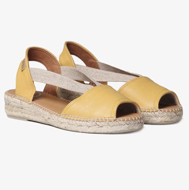Leather espadrille sandals with a wedge heel, breathable lining, and slip-on design. Ideal for casual wear, featuring a low heel and rubber sole for comfort