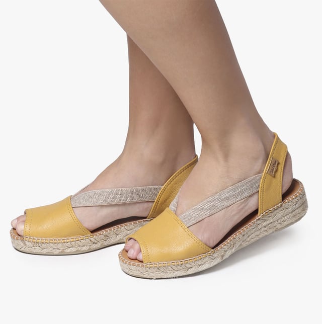 Leather espadrille sandals with a wedge heel, breathable lining, and slip-on design. Ideal for casual wear, featuring a low heel and rubber sole for comfort