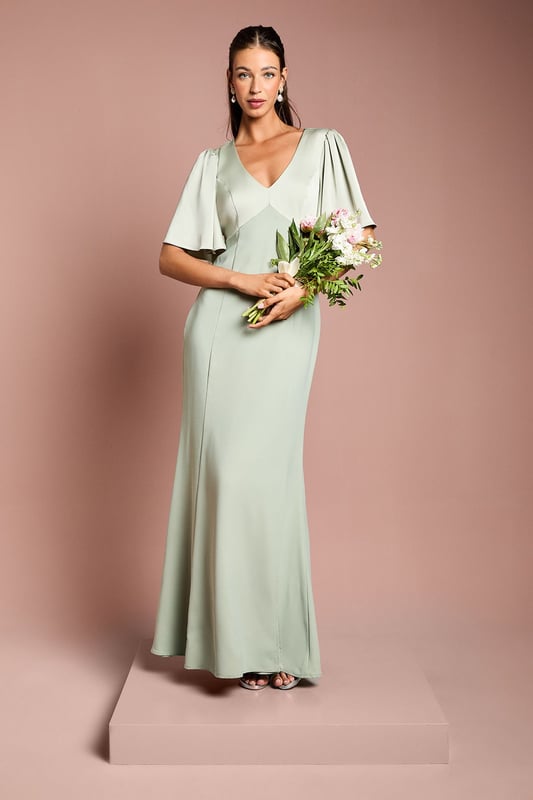 Elegant V-neckline for a flattering silhouette
        Graceful angel sleeves add a touch of romance
        Striking open back design with tie detail
        Floor-length skirt for a sophisticated look
        Luxurious satin fabric for a polished finish
    
    This stunning bridesmaids dress from Coast is the epitome of elegance and grace. Perfect for your role in the bridal party, this gown combines classic sophistication with modern details. The V-neckline and angel sleeves create a romantic silhouette, while the open back with tie detail adds a contemporary twist. The floor-length skirt ensures a refined look as you walk down the aisle. Crafted from sumptuous satin, this dress drapes beautifully and catches the light in all the right ways. Pair with delicate jewellery and strappy heels to complete your bridesmaid ensemble. Whether you're standing beside the bride or dancing the night away at the reception, this dress will ensure you look and feel fabulous throughout the wedding celebrations.