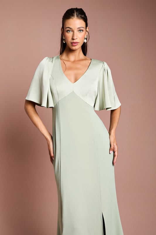 Elegant V-neckline for a flattering silhouette
        Graceful angel sleeves add a touch of romance
        Striking open back design with tie detail
        Floor-length skirt for a sophisticated look
        Luxurious satin fabric for a polished finish
    
    This stunning bridesmaids dress from Coast is the epitome of elegance and grace. Perfect for your role in the bridal party, this gown combines classic sophistication with modern details. The V-neckline and angel sleeves create a romantic silhouette, while the open back with tie detail adds a contemporary twist. The floor-length skirt ensures a refined look as you walk down the aisle. Crafted from sumptuous satin, this dress drapes beautifully and catches the light in all the right ways. Pair with delicate jewellery and strappy heels to complete your bridesmaid ensemble. Whether you're standing beside the bride or dancing the night away at the reception, this dress will ensure you look and feel fabulous throughout the wedding celebrations.