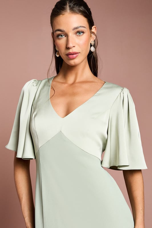 Elegant V-neckline for a flattering silhouette
        Graceful angel sleeves add a touch of romance
        Striking open back design with tie detail
        Floor-length skirt for a sophisticated look
        Luxurious satin fabric for a polished finish
    
    This stunning bridesmaids dress from Coast is the epitome of elegance and grace. Perfect for your role in the bridal party, this gown combines classic sophistication with modern details. The V-neckline and angel sleeves create a romantic silhouette, while the open back with tie detail adds a contemporary twist. The floor-length skirt ensures a refined look as you walk down the aisle. Crafted from sumptuous satin, this dress drapes beautifully and catches the light in all the right ways. Pair with delicate jewellery and strappy heels to complete your bridesmaid ensemble. Whether you're standing beside the bride or dancing the night away at the reception, this dress will ensure you look and feel fabulous throughout the wedding celebrations.