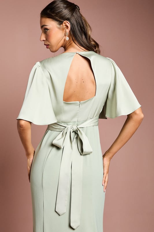 Elegant V-neckline for a flattering silhouette
        Graceful angel sleeves add a touch of romance
        Striking open back design with tie detail
        Floor-length skirt for a sophisticated look
        Luxurious satin fabric for a polished finish
    
    This stunning bridesmaids dress from Coast is the epitome of elegance and grace. Perfect for your role in the bridal party, this gown combines classic sophistication with modern details. The V-neckline and angel sleeves create a romantic silhouette, while the open back with tie detail adds a contemporary twist. The floor-length skirt ensures a refined look as you walk down the aisle. Crafted from sumptuous satin, this dress drapes beautifully and catches the light in all the right ways. Pair with delicate jewellery and strappy heels to complete your bridesmaid ensemble. Whether you're standing beside the bride or dancing the night away at the reception, this dress will ensure you look and feel fabulous throughout the wedding celebrations.