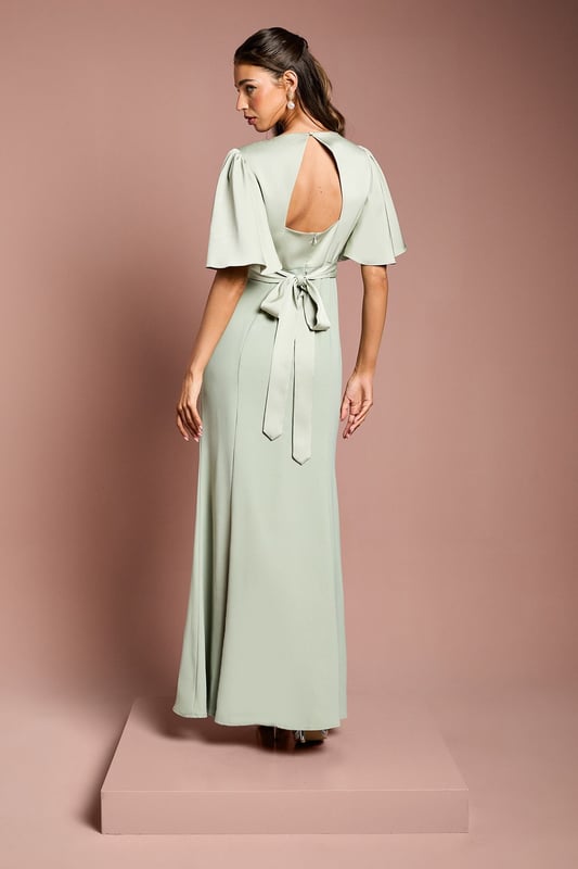 Elegant V-neckline for a flattering silhouette
        Graceful angel sleeves add a touch of romance
        Striking open back design with tie detail
        Floor-length skirt for a sophisticated look
        Luxurious satin fabric for a polished finish
    
    This stunning bridesmaids dress from Coast is the epitome of elegance and grace. Perfect for your role in the bridal party, this gown combines classic sophistication with modern details. The V-neckline and angel sleeves create a romantic silhouette, while the open back with tie detail adds a contemporary twist. The floor-length skirt ensures a refined look as you walk down the aisle. Crafted from sumptuous satin, this dress drapes beautifully and catches the light in all the right ways. Pair with delicate jewellery and strappy heels to complete your bridesmaid ensemble. Whether you're standing beside the bride or dancing the night away at the reception, this dress will ensure you look and feel fabulous throughout the wedding celebrations.