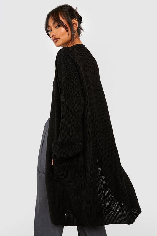 Oversized boyfriend fit for a relaxed, effortless look
        Edge-to-edge design with no fastenings for easy layering
        Chunky knit texture adds depth and warmth
        V-neckline enhances the casual, laid-back vibe
        Long sleeves with ribbed cuffs for a cosy finish
    
    Embrace the casual-cool aesthetic with this Fisherman Edge To Edge Boyfriend Cardigan from Boohoo. Perfect for those who love to blend comfort with style, this oversized piece is a versatile addition to any wardrobe. Layer it over a crop top and wide-leg trousers for an on-trend look that's ideal for coffee dates or casual outings. The chunky knit texture not only provides warmth but also adds an interesting visual element to your ensemble. For a more polished appearance, pair it with a fitted dress and ankle boots. This cardigan is your go-to for creating effortlessly chic outfits, whether you're heading to a family gathering or a relaxed day out with friends. Its adaptable nature makes it a staple for the fashion-forward woman who values both style and comfort in her everyday wear.