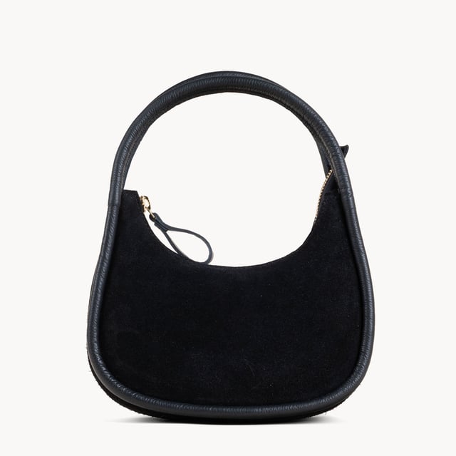 Sashay in style with the 'FAYE' mini grab bag. Beautifully handcrafted from fine napped real suede leather, this grab bag is both luxurious and lightweight. With a tubular handle and zip closure, it's perfect for carrying your essentials. And with its designer touch, you'll be the envy of every fashionista. Handcrafted with fine napped Suede real leather. Zip top handbag for security of your essentials. Slip in pockets for your mobile and other necessities. Tubular handheld leather grab handle. Fully lined interiors. Internal utility features, include: Mobile pocket, Slip-in pocket. Fittings: Antique Brass. Composition: Body: 100% Genuine Leather, Lining: Matching Polyester.