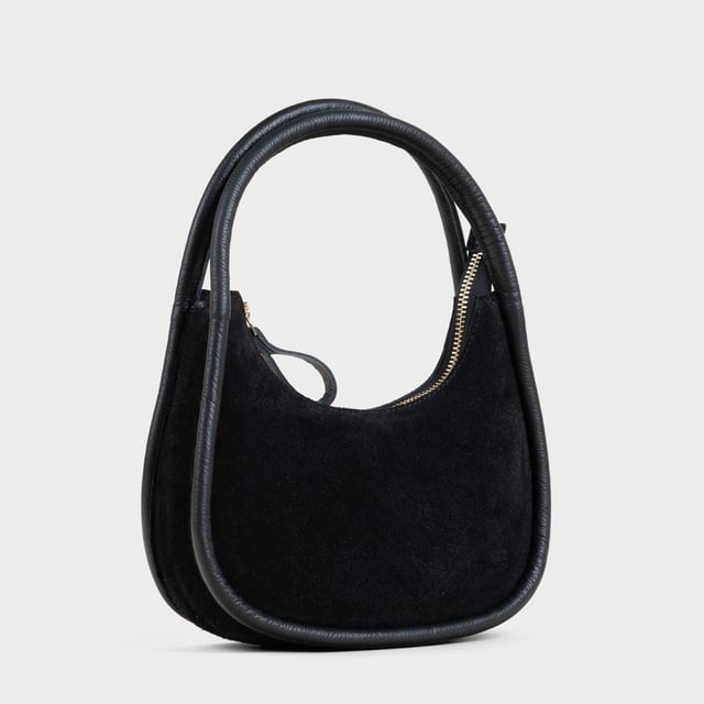 Sashay in style with the 'FAYE' mini grab bag. Beautifully handcrafted from fine napped real suede leather, this grab bag is both luxurious and lightweight. With a tubular handle and zip closure, it's perfect for carrying your essentials. And with its designer touch, you'll be the envy of every fashionista. Handcrafted with fine napped Suede real leather. Zip top handbag for security of your essentials. Slip in pockets for your mobile and other necessities. Tubular handheld leather grab handle. Fully lined interiors. Internal utility features, include: Mobile pocket, Slip-in pocket. Fittings: Antique Brass. Composition: Body: 100% Genuine Leather, Lining: Matching Polyester.
