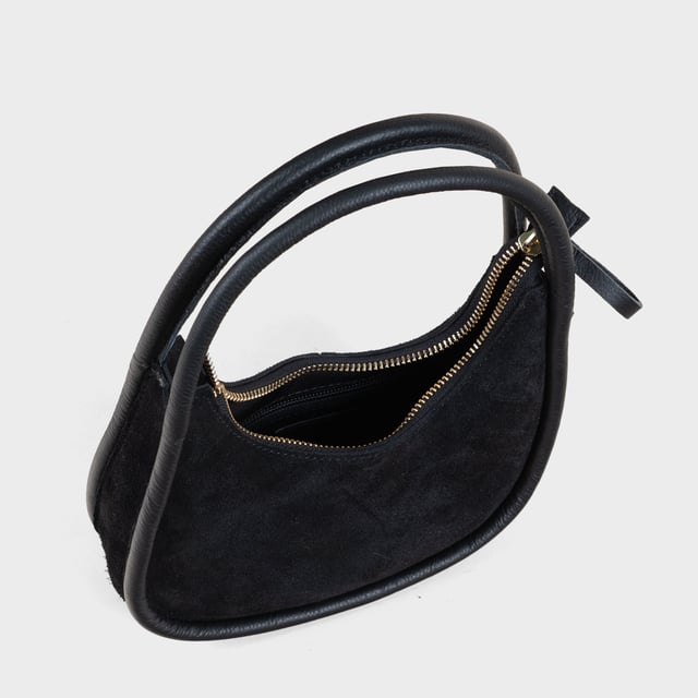 Sashay in style with the 'FAYE' mini grab bag. Beautifully handcrafted from fine napped real suede leather, this grab bag is both luxurious and lightweight. With a tubular handle and zip closure, it's perfect for carrying your essentials. And with its designer touch, you'll be the envy of every fashionista. Handcrafted with fine napped Suede real leather. Zip top handbag for security of your essentials. Slip in pockets for your mobile and other necessities. Tubular handheld leather grab handle. Fully lined interiors. Internal utility features, include: Mobile pocket, Slip-in pocket. Fittings: Antique Brass. Composition: Body: 100% Genuine Leather, Lining: Matching Polyester.
