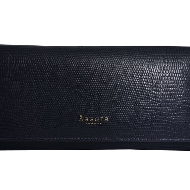 The ‘Claire’ flapover ladies purse is handcrafted with the premium lizard textured leather to give that designer look. Equipped with RFID technology, this practical ladies purse features a magnetic fastening closure with plenty of room to organise your cash, cards and coins. This large leather ladies purse is perfect to compliment your handbag and fits in easily. Stay safe and organised with ‘Claire’ the perfect addition to your collection of purses ideal for all outfits and occasions. Secured flap over magnetic fastening closure to store your essentials safely and securely. Foldover flap design. Equipped with RFID technology for safety. Additional back zip pocket to ensure you don’t run out of space. Two note compartments. Eight internal card compartments. Two windowed ID slots. Assots branded lined interiors. Lightweight for easy carry. Fittings Colour: Clean Brass. Composition: Body: 100% Genuine Leather. Lining: 100% Cotton. DISCLAIMER : All pictures shown are for illustration purpose only. Actual product colour may vary due to different ambience lighting or the screen display settings.
