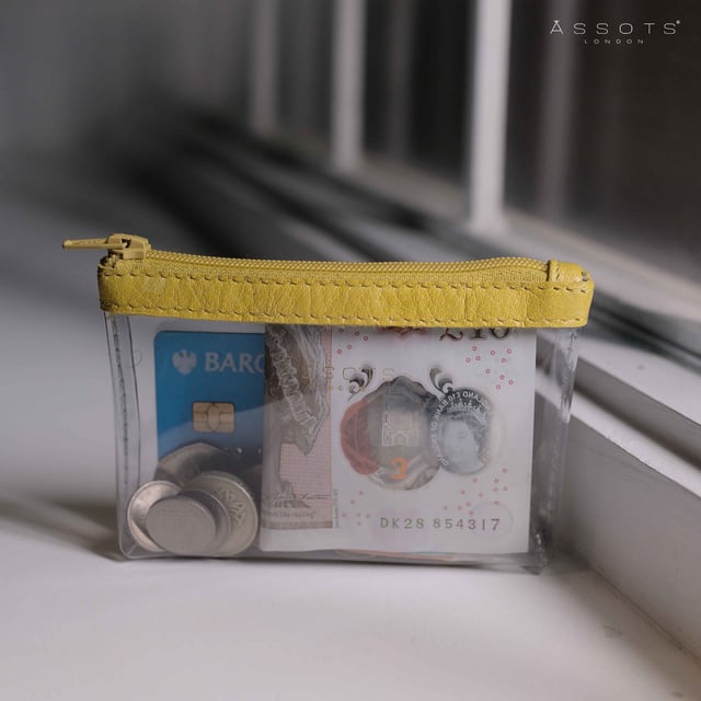 Size:13cm x 8.5cm x 2cm. The Dinah Transparent Zip Top Coin Purse is a unique handcrafted leather accessory that combines practicality with a fashionable twist. Its transparent design is sure to draw attention, while its compact size makes it an ideal accessory for any occasion. Composition:Body: Genuine Leather, PU transparent, Lining: Polyester.