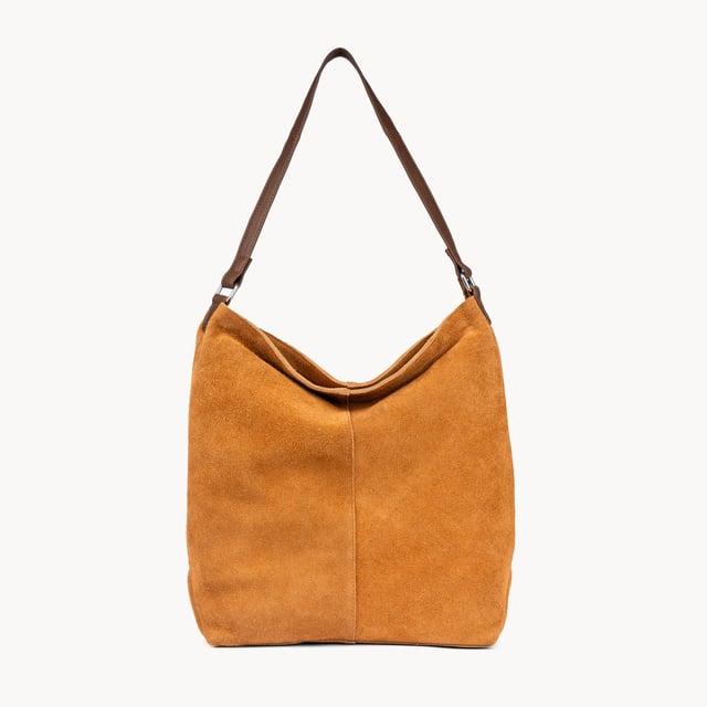 Size: 34cm x 35cm x 8cm. The ‘Tina’ designer slouchy tote bag is a refined statement of luxury and everyday versatility. Crafted from premium suede leather, it features a secure zip closure and a roomy, unlined interior, showcasing the authentic beauty of genuine leather. Thoughtfully designed for the modern professional, this timeless tote transitions effortlessly from business meetings to casual outings and evening events, offering a perfect combination of sophistication and practicality. Crafted from fine-napped suede leather for that slouchy look. Smooth zipper opens to a roomy unlined interior, offering both style and functionality. Extra-long full grain leather shoulder handles ensure a secure, slip-free fit, even over an overcoat. Internal secured zip pocket keeps your mobile phone, car keys, and house keys safe and accessible. Composition: Body - 100% Genuine Leather, Hardware -  Shiny Silver, Lining - Unlined.