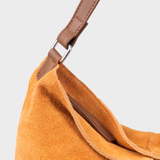 Size: 34cm x 35cm x 8cm. The ‘Tina’ designer slouchy tote bag is a refined statement of luxury and everyday versatility. Crafted from premium suede leather, it features a secure zip closure and a roomy, unlined interior, showcasing the authentic beauty of genuine leather. Thoughtfully designed for the modern professional, this timeless tote transitions effortlessly from business meetings to casual outings and evening events, offering a perfect combination of sophistication and practicality. Crafted from fine-napped suede leather for that slouchy look. Smooth zipper opens to a roomy unlined interior, offering both style and functionality. Extra-long full grain leather shoulder handles ensure a secure, slip-free fit, even over an overcoat. Internal secured zip pocket keeps your mobile phone, car keys, and house keys safe and accessible. Composition: Body - 100% Genuine Leather, Hardware -  Shiny Silver, Lining - Unlined.